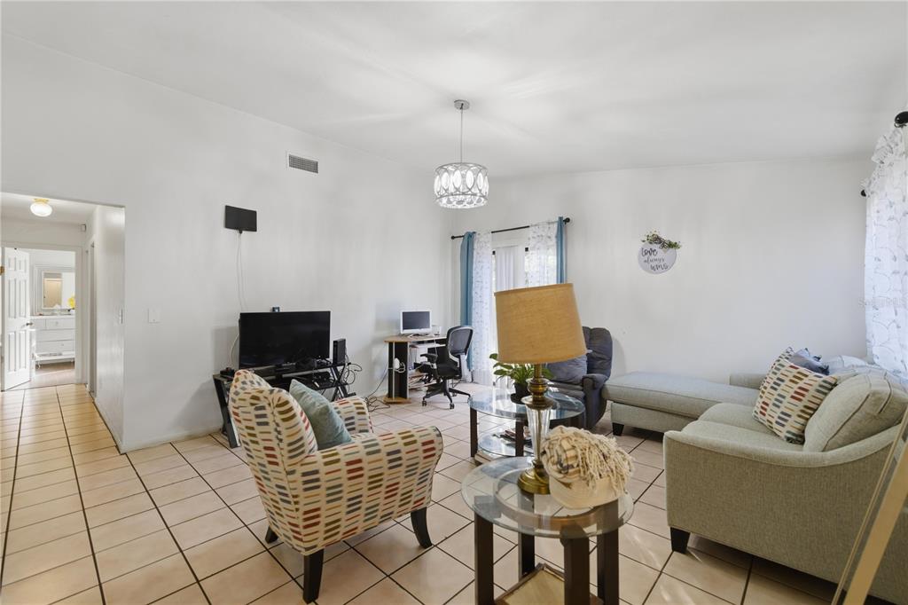 1939 Southwest 73rd Terrace Gainesville, FL 32607 - Photo 9 of 26 a living room with furniture and a flat screen tv