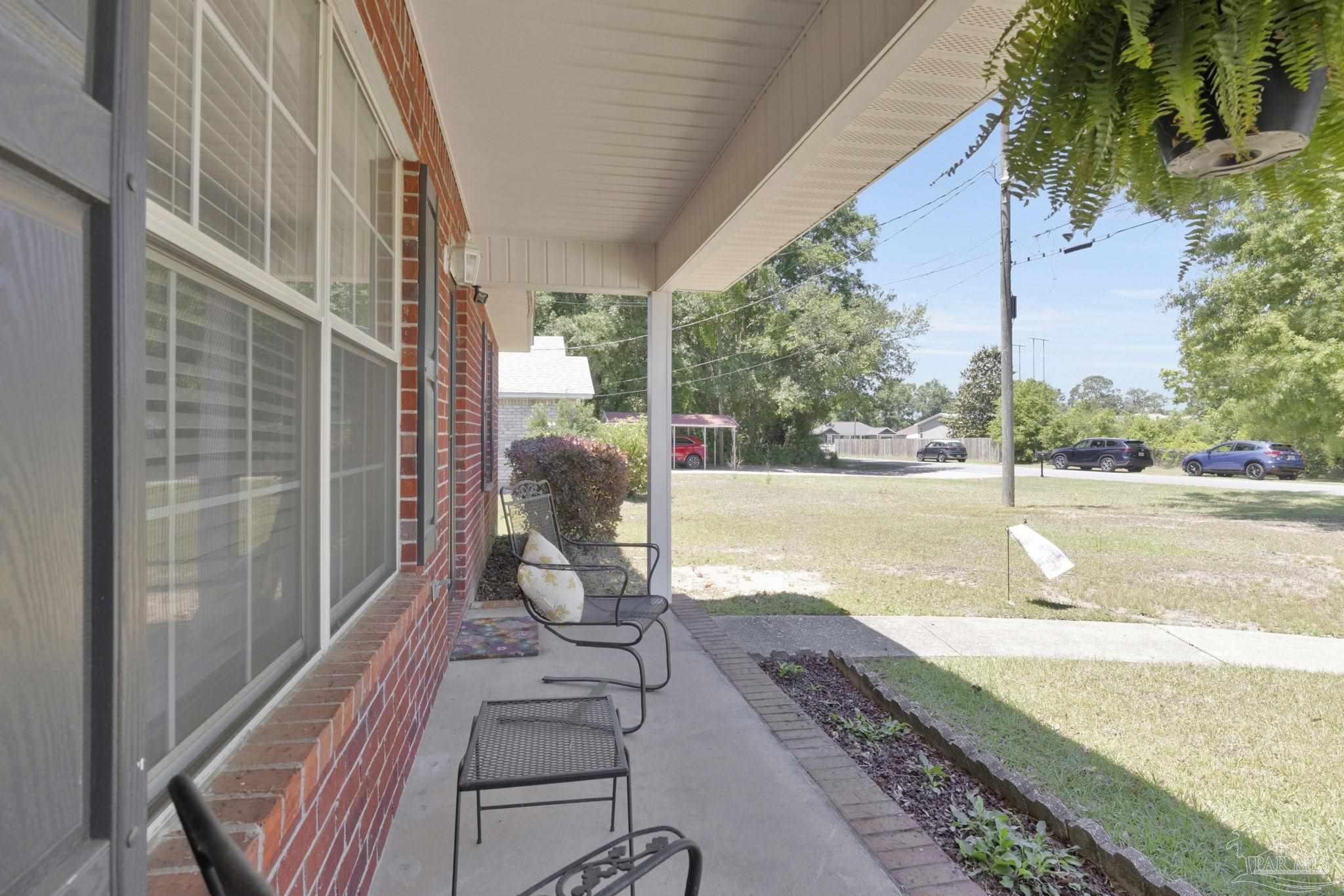 5539 Windrun Place Pace, FL 32571 - Photo 41 of 62 a view of a porch with wooden floor