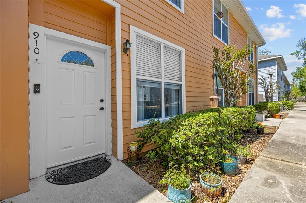 3970 Southwest 20th Avenue, Unit 910 Gainesville, FL 32607 - Photo 1 of 1 a front view of a house with a yard
