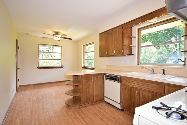 237 Blackhawk Road Riverside, IL 60546 - Photo 11 of 23 a kitchen with a sink and wooden floor
