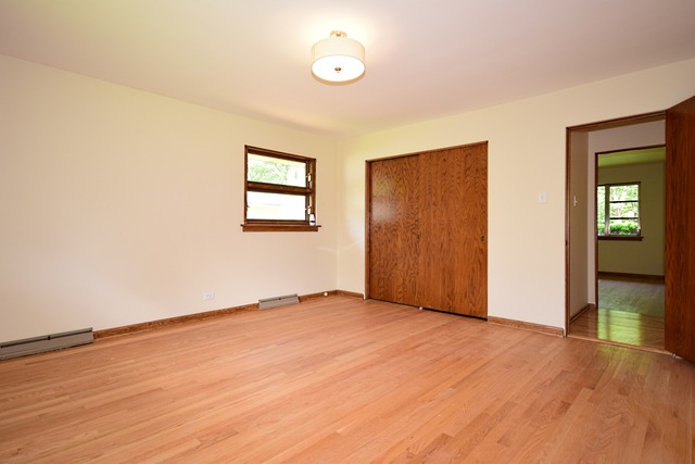 237 Blackhawk Road Riverside, IL 60546 - Photo 12 of 23 an empty room with wooden floor and windows