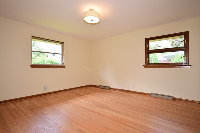 237 Blackhawk Road Riverside, IL 60546 - Photo 13 of 23 an empty room with wooden floor and windows