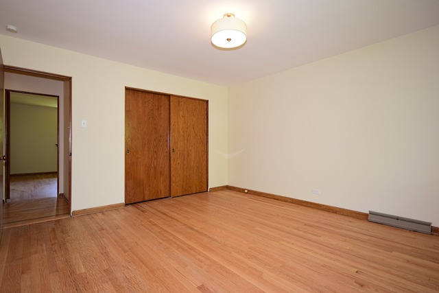 237 Blackhawk Road Riverside, IL 60546 - Photo 16 of 23 an empty room with wooden floor and windows