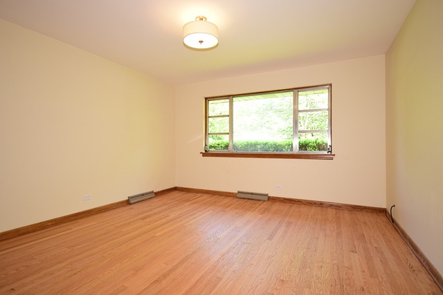 237 Blackhawk Road Riverside, IL 60546 - Photo 17 of 23 an empty room with wooden floor and windows