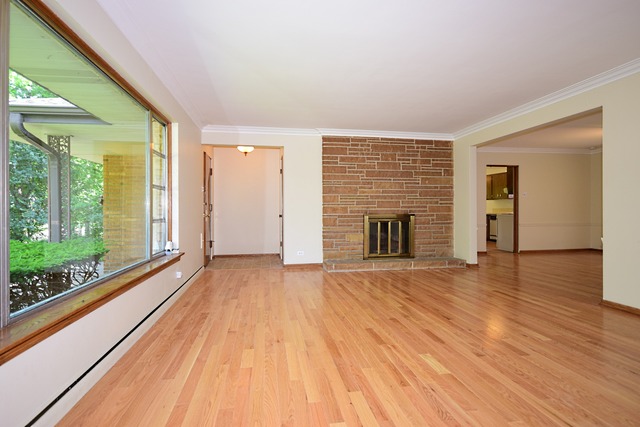 237 Blackhawk Road Riverside, IL 60546 - Photo 3 of 23 a view of empty room with wooden floor and fireplace