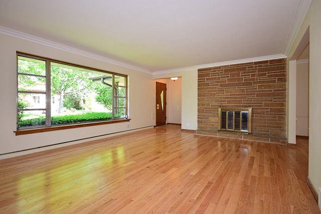 237 Blackhawk Road Riverside, IL 60546 - Photo 4 of 23 a view of empty room with wooden floor and fireplace