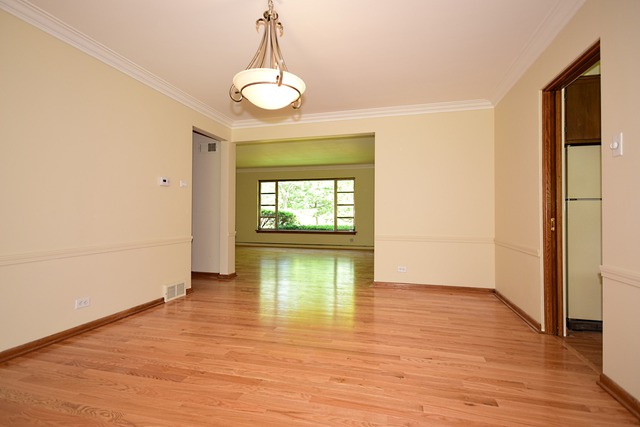 237 Blackhawk Road Riverside, IL 60546 - Photo 5 of 23 a view of an empty room with window and wooden floor