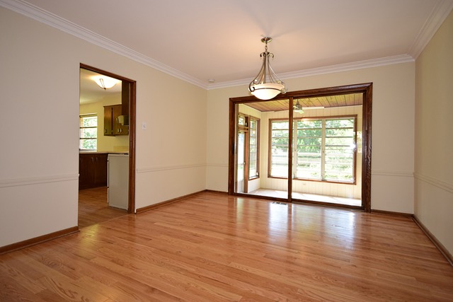 237 Blackhawk Road Riverside, IL 60546 - Photo 6 of 23 a view of an empty room with window and wooden floor