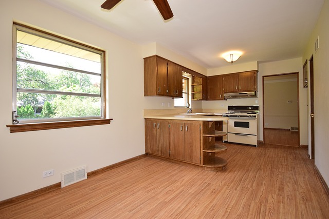 237 Blackhawk Road Riverside, IL 60546 - Photo 10 of 23 a kitchen with stainless steel appliances a stove top oven a sink dishwasher and a refrigerator with wooden floor