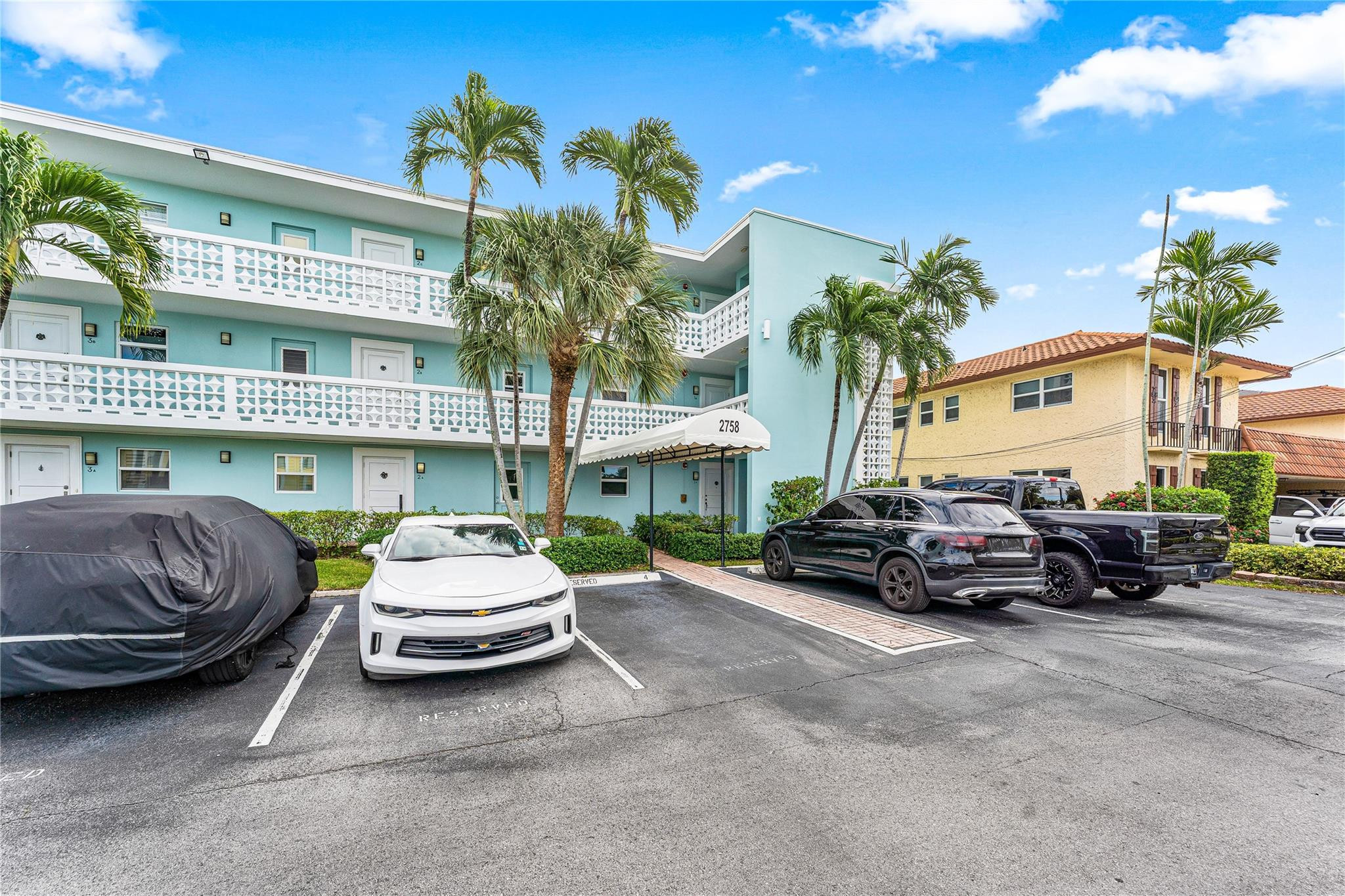 2758 Northeast 30th Avenue, Unit 1A Lighthouse Point, FL 33064 - Photo 23 of 48 a view of a car parked in front of a building