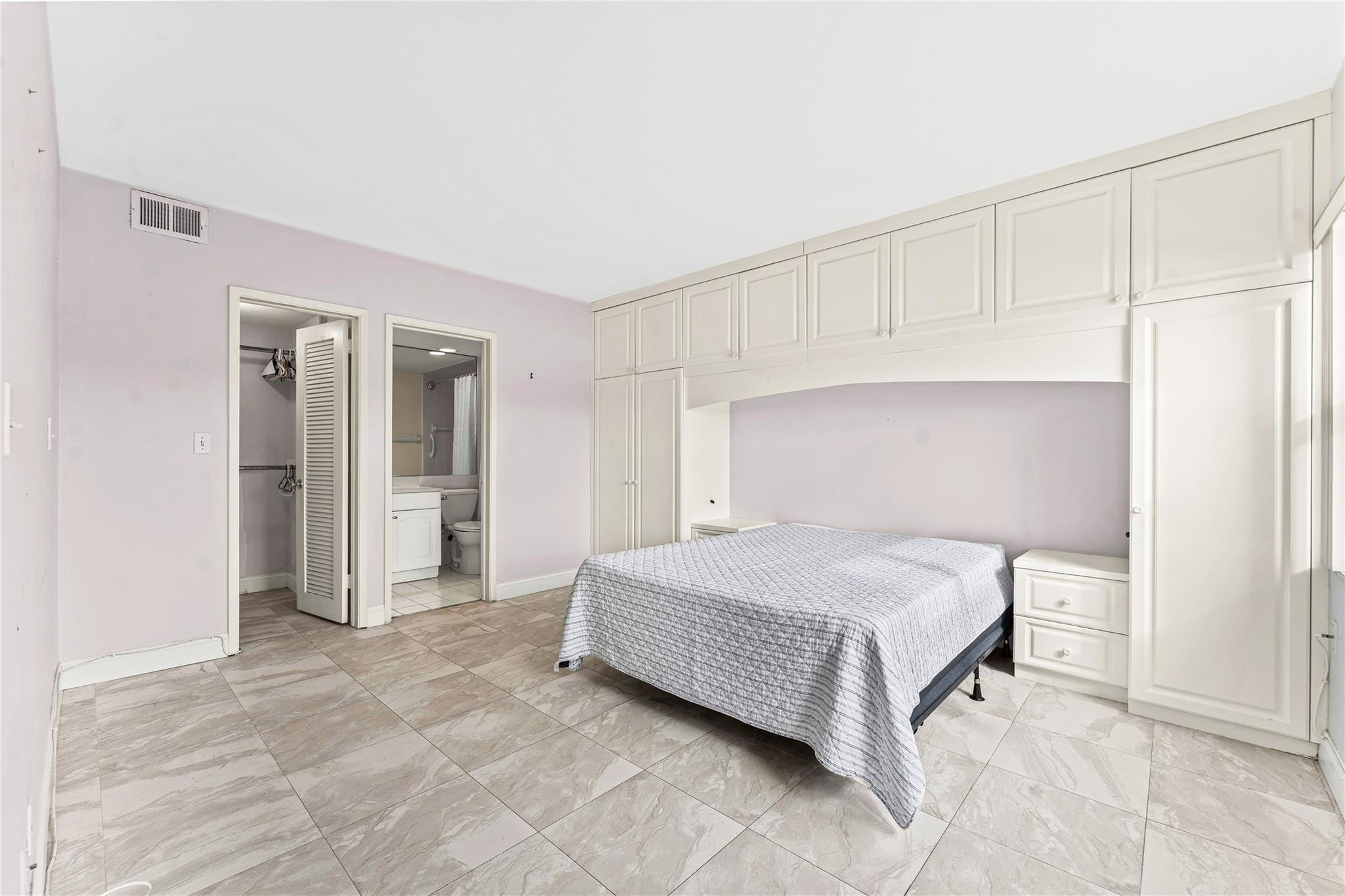 2758 Northeast 30th Avenue, Unit 1A Lighthouse Point, FL 33064 - Photo 34 of 48 a bedroom with a bed and closet