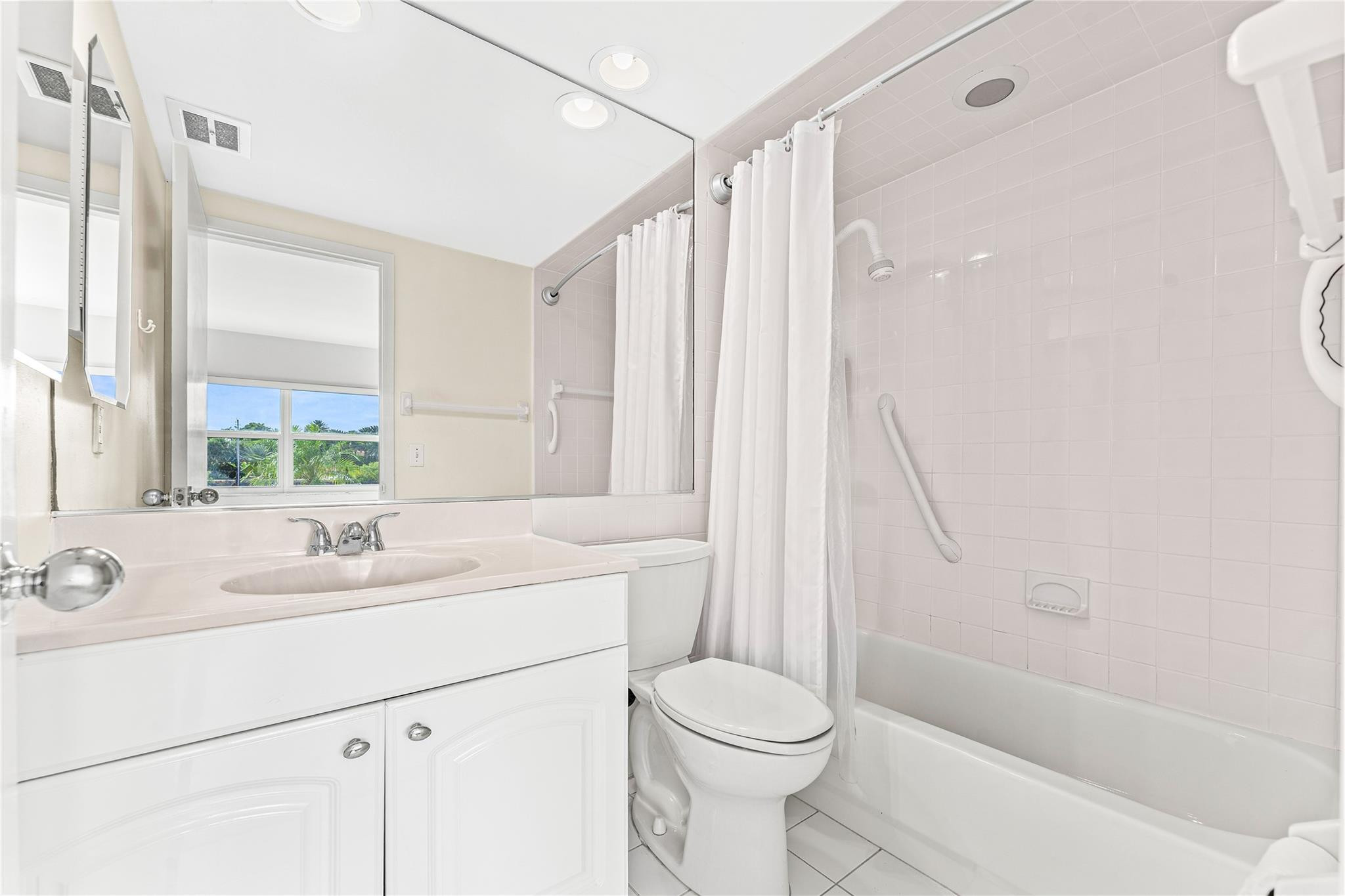 2758 Northeast 30th Avenue, Unit 1A Lighthouse Point, FL 33064 - Photo 35 of 48 a bathroom with a sink toilet and shower