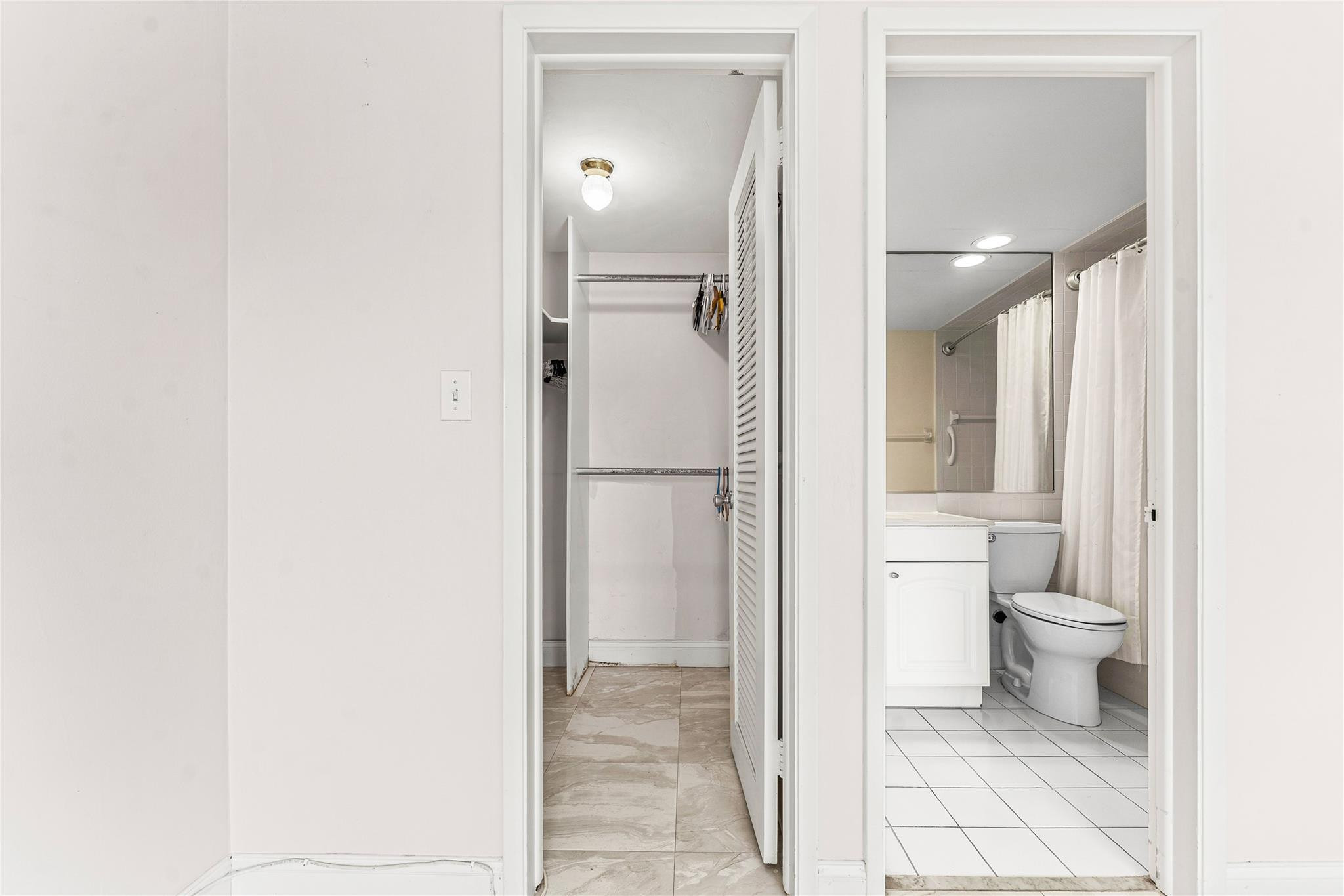 2758 Northeast 30th Avenue, Unit 1A Lighthouse Point, FL 33064 - Photo 36 of 48 a bathroom with a granite countertop toilet and a shower