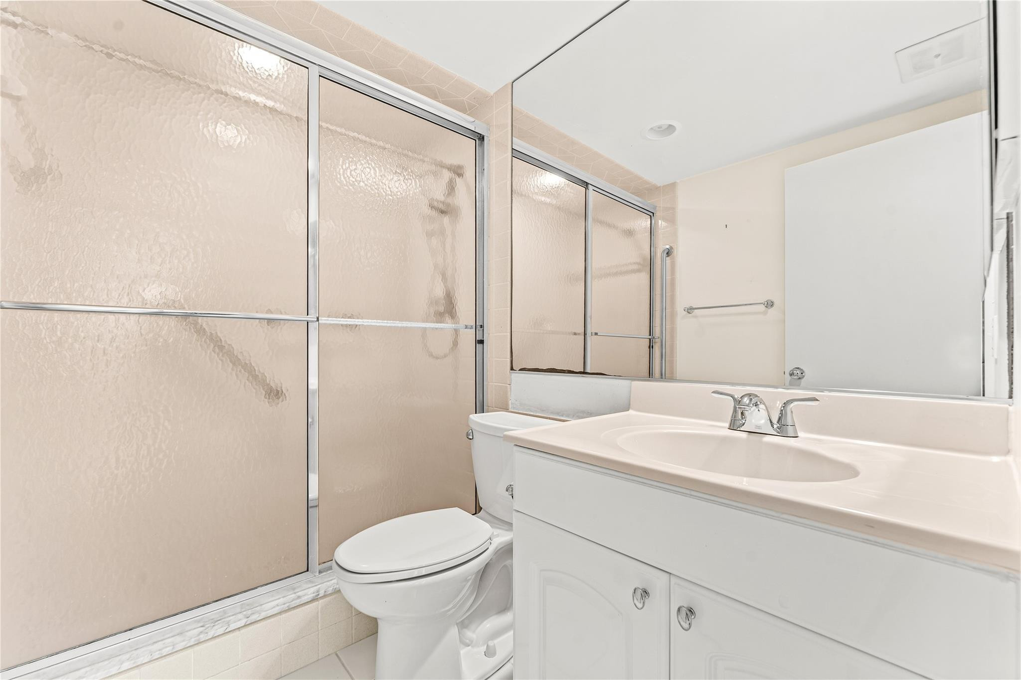 2758 Northeast 30th Avenue, Unit 1A Lighthouse Point, FL 33064 - Photo 40 of 48 a bathroom with a sink a toilet and shower