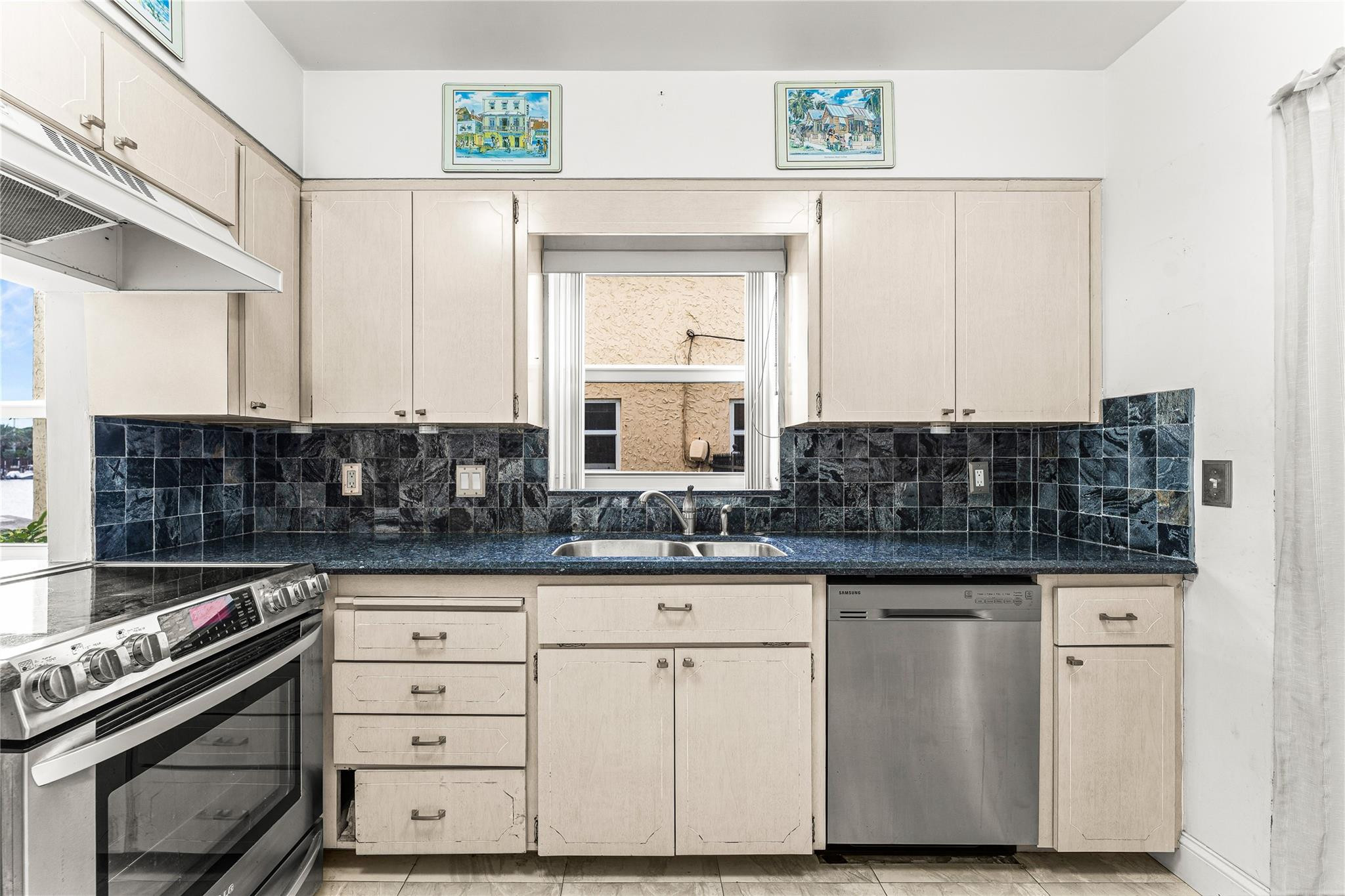 2758 Northeast 30th Avenue, Unit 1A Lighthouse Point, FL 33064 - Photo 6 of 48 a kitchen with granite countertop a sink and a stove