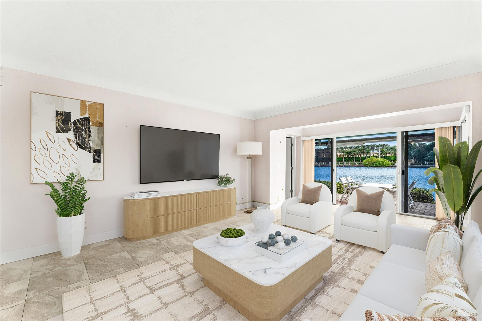 2758 Northeast 30th Avenue, Unit 1A Lighthouse Point, FL 33064 - Photo 10 of 48 a living room with furniture a flat screen tv and a floor to ceiling window