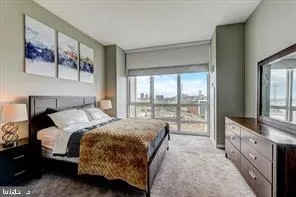 a bedroom with a large bed and a large window