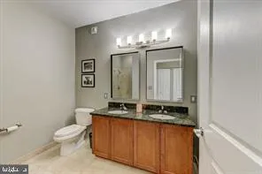 a bathroom with a toilet sink and mirror