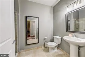 a bathroom with a toilet sink and mirror