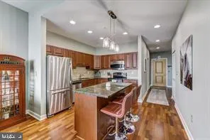 a kitchen with stainless steel appliances granite countertop a refrigerator and a sink