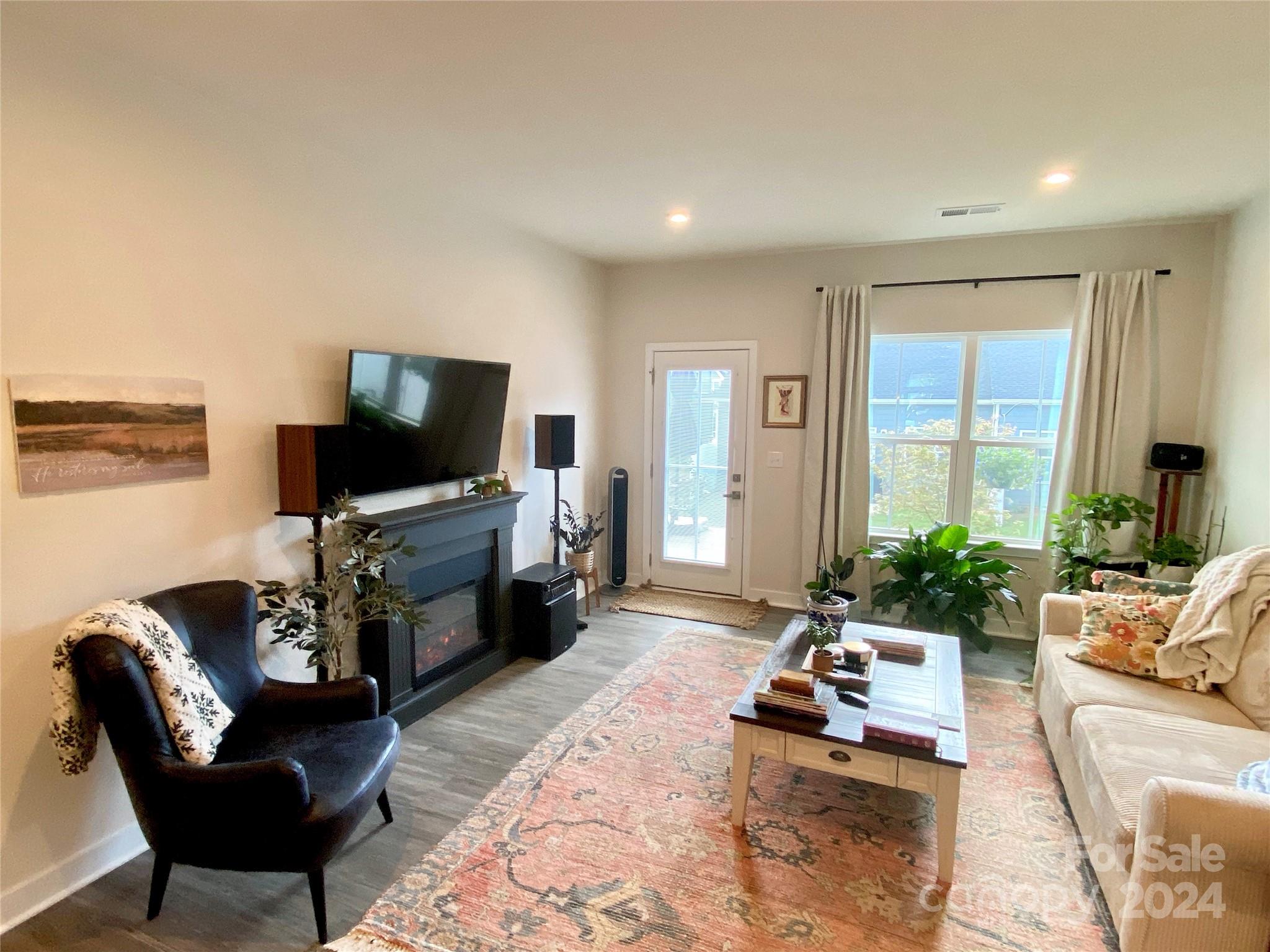 765 Hazel Way Denver, NC 28037 - Photo 12 of 35 a living room with furniture and a flat screen tv