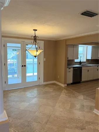 an empty room with wooden floor and a ceiling fan