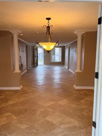 an aerial view of a city with lots of residential buildings ocean and mountain view in back