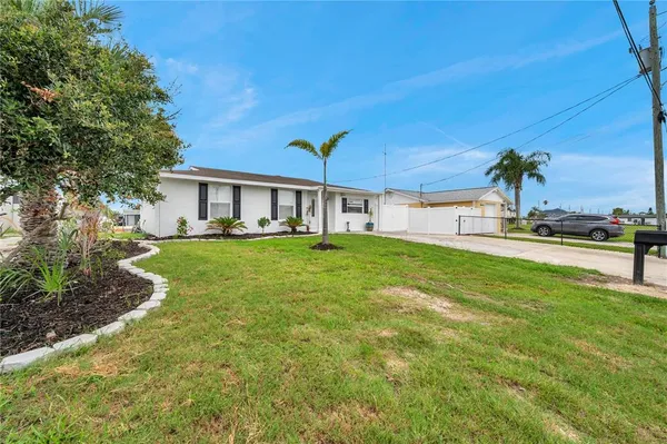 a kitchen with a sink a refrigerator and cabinets