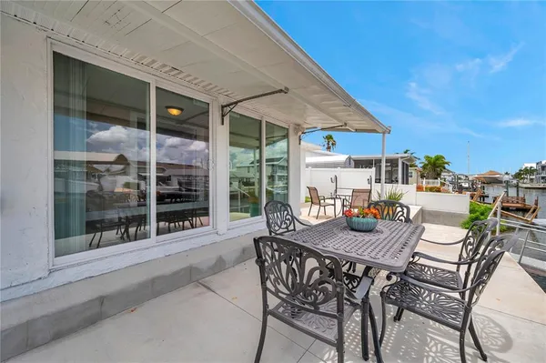 a kitchen with stainless steel appliances granite countertop a refrigerator a sink dishwasher a stove top oven a refrigerator with white cabinets and wooden floor