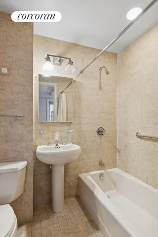 a bathroom with a sink mirror toilet and bathtub