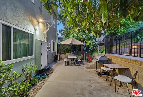 a view of swimming pool with outdoor seating and plants