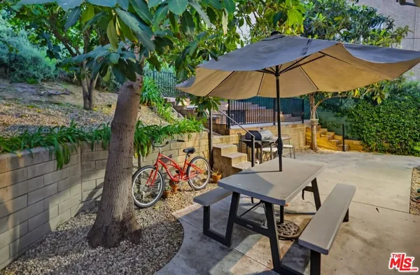 a patio with patio a couch and potted plants
