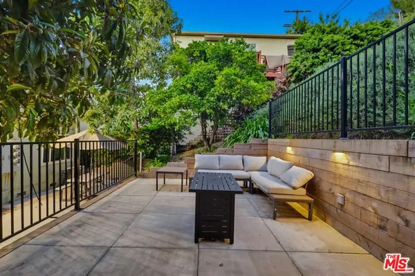 a view of a chairs and tables in the backyard