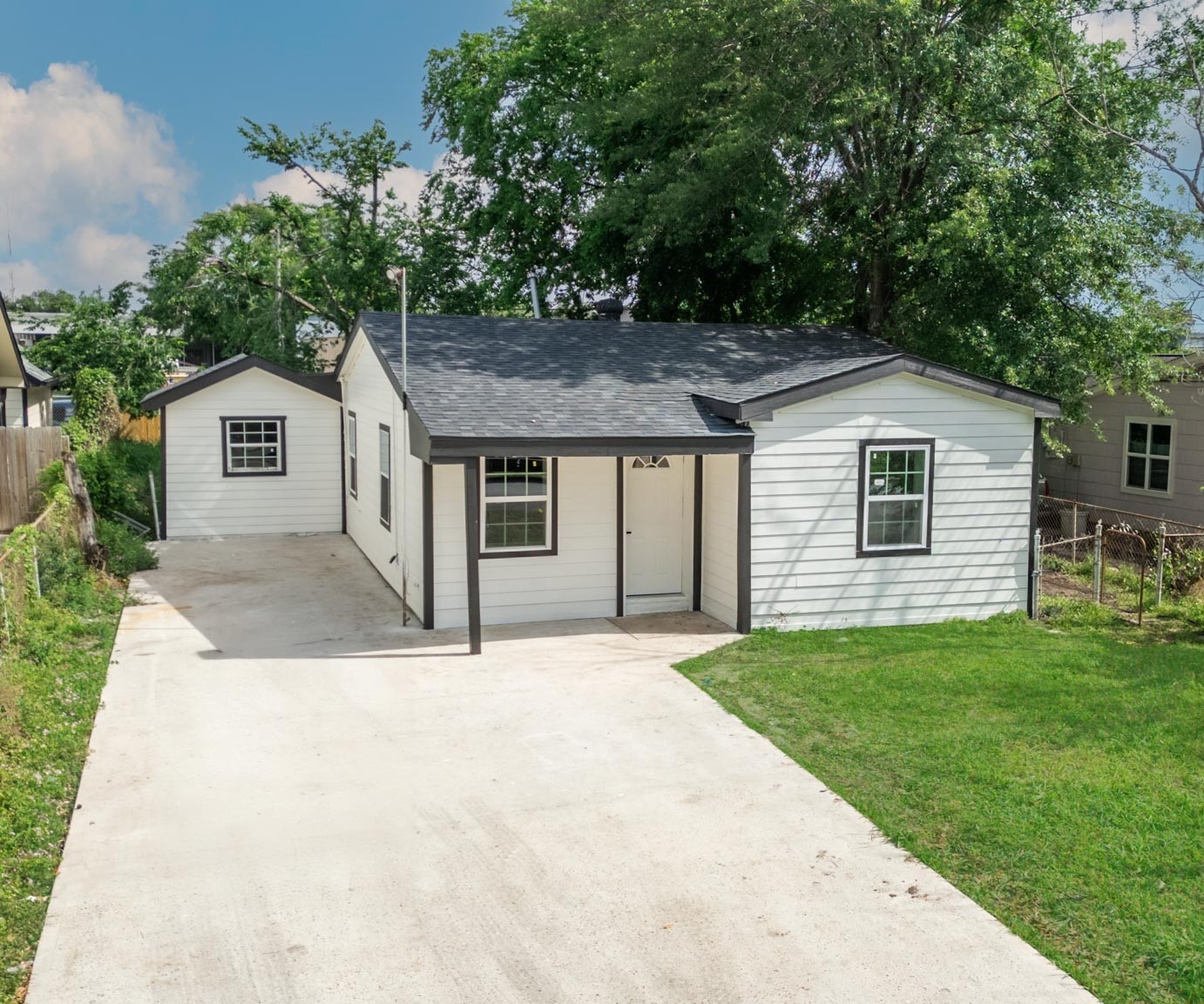 10309 Wiggins Street Houston, TX 77029 - Photo 29 of 32 a front view of a house with a garden and yard