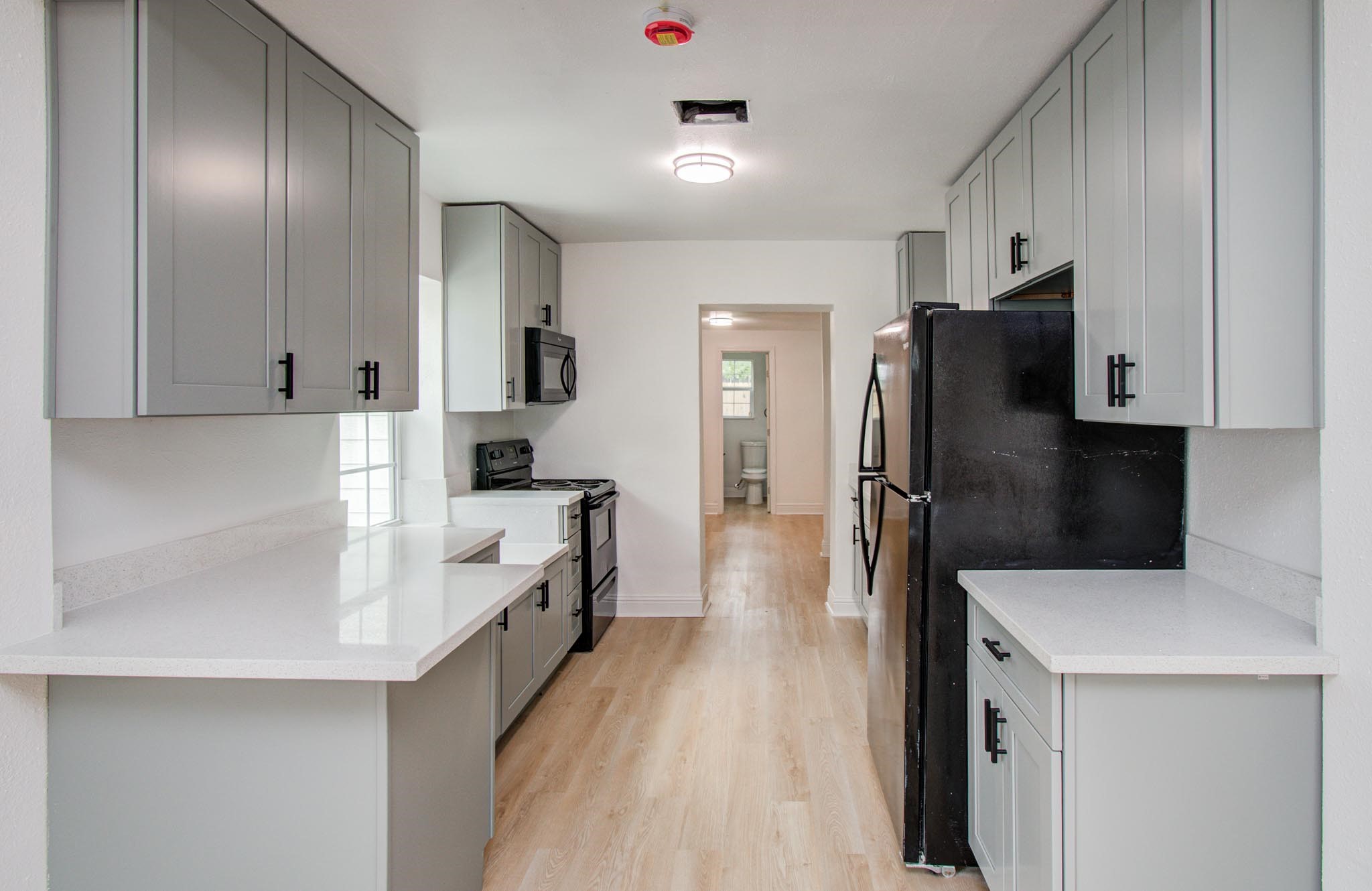 10309 Wiggins Street Houston, TX 77029 - Photo 9 of 32 a kitchen with stainless steel appliances a refrigerator sink and stove