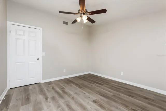 a view of a room with wooden floor