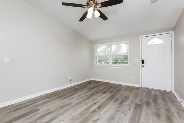 wooden floor in an empty room with a window