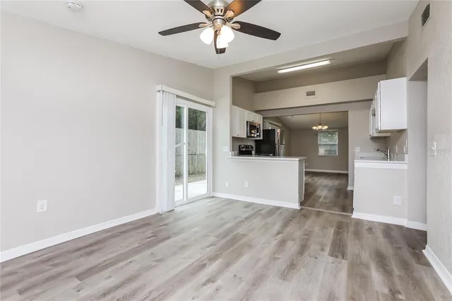 a view of wooden floor and a kitchen