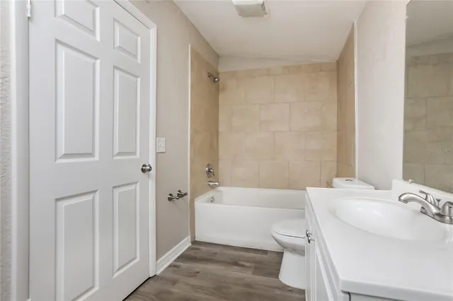 a bathroom with a sink a toilet and bathtub