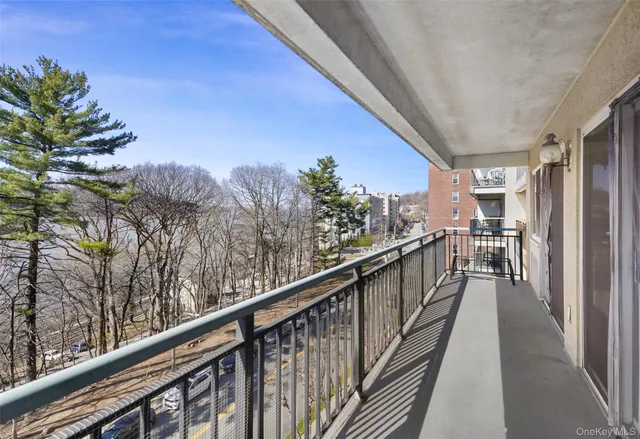 a view of a balcony with wooden floor and fence