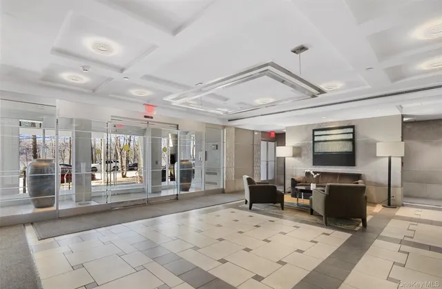 a lobby with furniture and flat screen tv