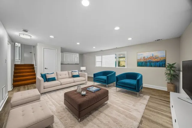 a living room with furniture ceiling fan and a rug