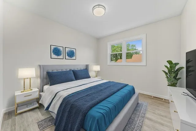a bedroom with bed and a potted plant