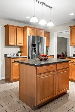 a kitchen with granite countertop a sink and cabinets