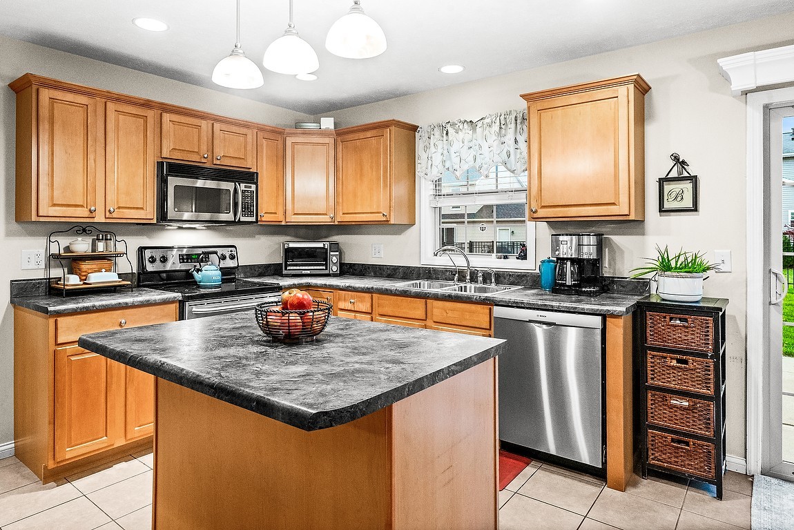 2985 Bear Claw Street Normal, IL 61761 - Photo 18 of 51 a kitchen with stainless steel appliances granite countertop a stove sink microwave and window