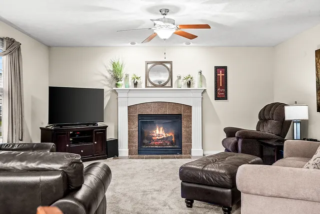 a living room with furniture and a fireplace