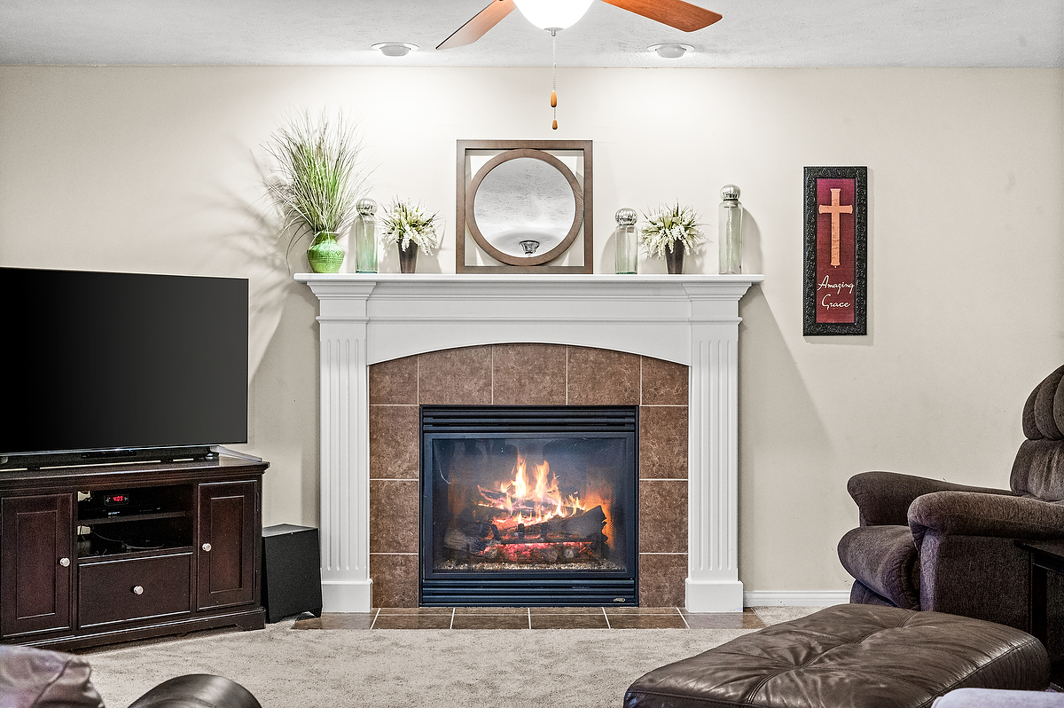 2985 Bear Claw Street Normal, IL 61761 - Photo 25 of 51 a living room with furniture a fireplace and a flat screen tv