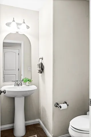 a bathroom with a sink mirror and toilet