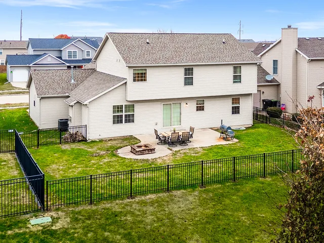 a view of a house with backyard sitting area and garden