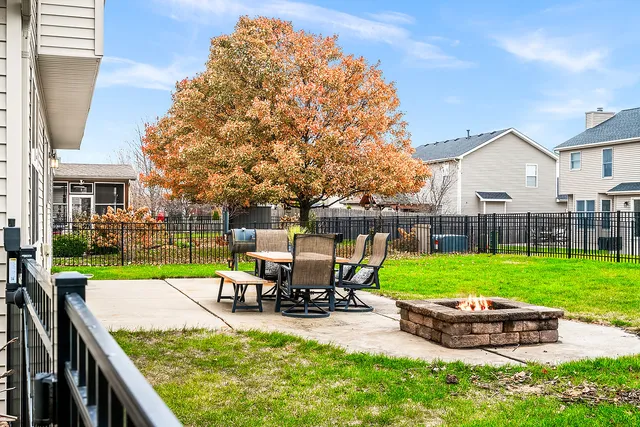 a view of a house with backyard sitting area and garden